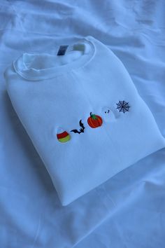 a white t - shirt with halloween embroidered on it