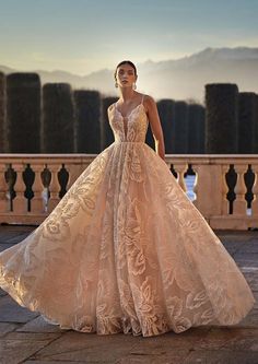 a woman in a wedding dress standing on a balcony