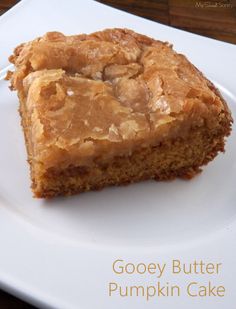 a piece of gooey butter pumpkin cake on a white plate with the words gooey butter pumpkin cake