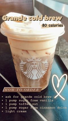 a cup of coffee sitting on top of a table next to a sign that reads, how to order