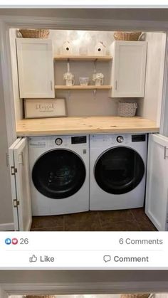 a washer and dryer in a small laundry room with cabinets above the washer