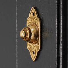 a black door with a gold handle and knob