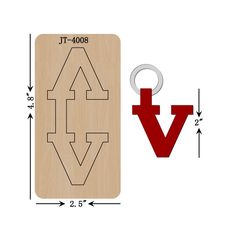 a wooden keychain with the word v on it next to an arrow shaped rubber stamp