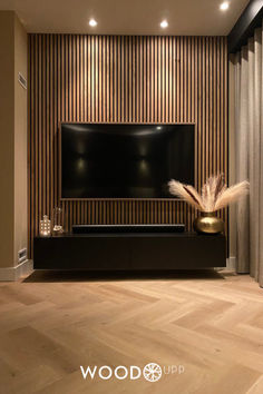 a large flat screen tv mounted to the side of a wall in a living room