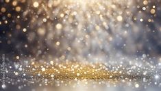 an abstract background with gold glitter and blurry lights