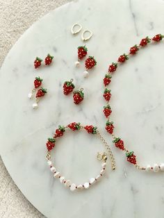 a white marble table topped with jewelry and bracelets