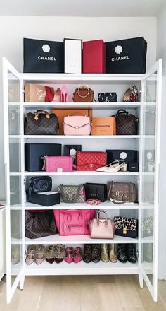 a white shelf filled with lots of purses and handbags on top of it