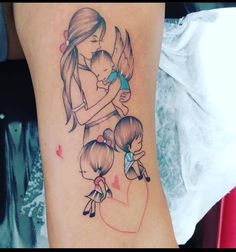 a woman holding a baby in her arms with an angel tattoo on her arm and behind her back