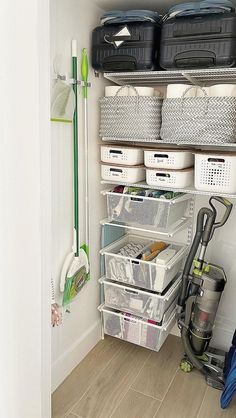 an organized closet with several bins and cleaning supplies on the shelf next to it