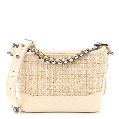 This is an authentic CHANEL Tweed Calfskin Quilted Small Gabrielle Hobo in Beige and Ivory. This chic shoulder bag is featured in diamond-stitched tweed in ivory and a sturdy smooth ivory white calfskin base. The crossbody bag features thin polished gold and ruthenium chain-link ivory leather threaded shoulder straps with a shoulder pad. The top zipper opens to a spacious beige fabric interior with zipper and patch pockets. Chanel Tweed, Leather Thread, Beige Fabric, Ivory White, Shoulder Pads, Chain Link, Shoulder Straps, Patch Pocket, Calf Skin