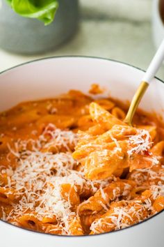 a white bowl filled with pasta and cheese