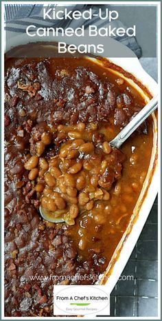 baked baked beans in a white casserole dish with the words, kicked up canned baked