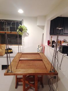 a wooden table sitting in the middle of a kitchen