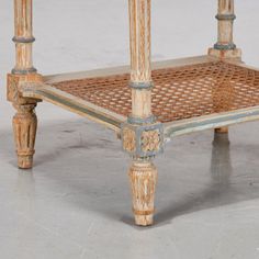 an old wooden table with wicker on top