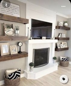 a living room filled with furniture and a flat screen tv mounted on a wall above a fire place