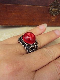 This is a great vintage ring from the 60s-early 70s. It is a thick and chunky style, with a wide decorative band in an antiqued silver tone metal, and a large red swirled lucite stone. It has an adjustable band, and will fit most ring sizes. This is well made, and has some wieght to it. The band has oxidized some, which gives it a great vintage style. Thank you for looking! Vintage Antique Silver Metal Rings, Red Retro Metal Jewelry, Retro Red Metal Jewelry, Vintage Red Nickel-free Jewelry, Retro Red Ring Jewelry, Vintage Engagement Rings Simple, Jewelry Chunky, Vintage Cocktail Ring, Simple Engagement Rings