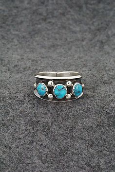 This turquoise and sterling silver ring was made by Navajo silversmith Paul Largo. The inside is stamped sterling.Size: 10Length: 1/2"Free shipping on all orders! We ship with USPS and always include tracking. All orders ship within a day of payment.Returns are accepted up to 30 days after you receive your order. Just send us a message. Our shop offers cash back or store credit. The item must be returned in new condition. Southwestern Style Turquoise Open Ring In Sterling Silver, Southwestern Turquoise Open Ring In Sterling Silver, Southwestern Sterling Silver Turquoise Open Ring, Sterling Silver Turquoise Ring, Perfect As A Gift, Nickel-free Southwestern Sterling Silver Rings, Southwestern Style Blue Nickel-free Rings, Gift Multi-stone Turquoise Ring In Sterling Silver, Navajo Rings, Adjustable Southwestern Turquoise Ring Nickel-free