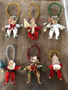 christmas ornaments are arranged on a sheet of paper and placed in the shape of angels