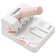 a pink and white sewing machine on a white background with the needle inserted into it