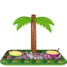 an inflatable palm tree with snacks and drinks on it is sitting next to a bowl of popcorn