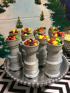 there are many cups with candy in them on the tray, and one is filled with candies