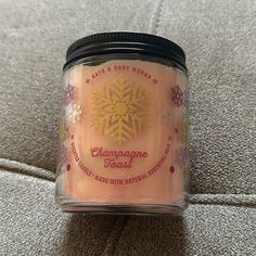 a candle that is sitting on top of a couch with the words champagne toast written on it