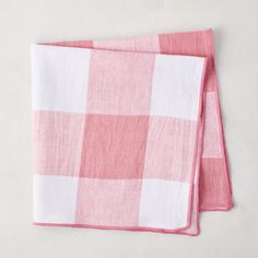 two pink and white checkered napkins sitting on top of each other