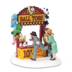 two figurines that are standing in front of a ball toss booth with stuffed animals on it