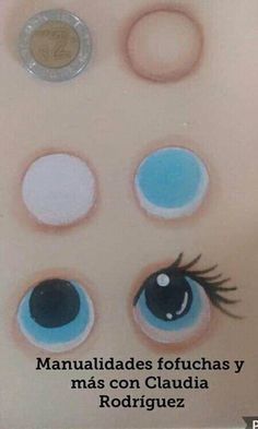 an image of the eyes of a doll with four different colored circles on it's face