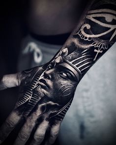 a man's hand with a tattoo on it