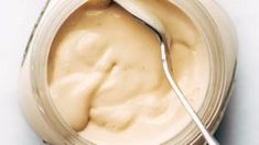 a spoon sticking out of a jar filled with mayonnaise