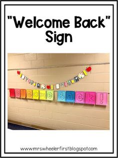 a welcome back sign hanging from the side of a wall