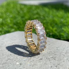 a gold ring sitting on top of a rock