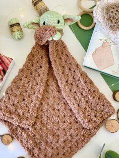 a crocheted blanket laying on top of a table