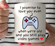 a woman is holding a coffee mug with a video game controller on it and the words i promise to love you even when old and you still play video games