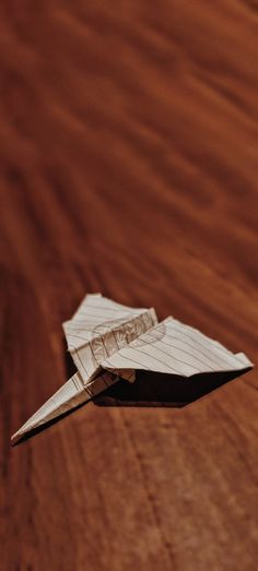 a paper airplane that is sitting on a table