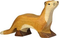 a small wooden animal is standing on its hind legs and it's head turned to look like an otter