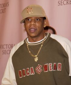 a young man wearing a baseball cap and sweatshirt