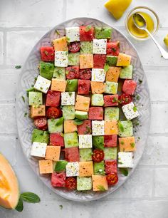 a platter filled with lots of different types of food on top of a table