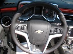 the interior of a car with steering wheel and dashboard