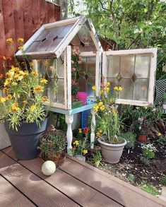 an outdoor garden with potted plants and flowers