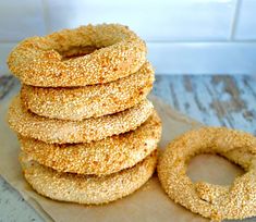 a stack of bagels sitting on top of a wooden table