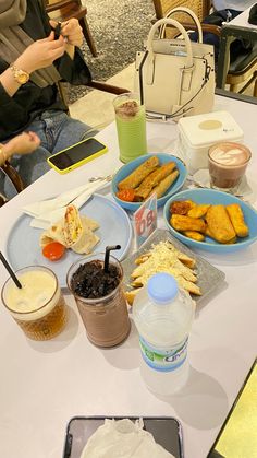 a table topped with plates of food and drinks