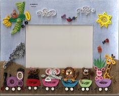 a photo frame decorated with animals and plants