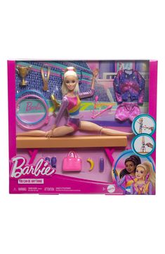 the barbie doll is sitting on top of a table