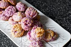 a white plate topped with cookies covered in powdered sugar