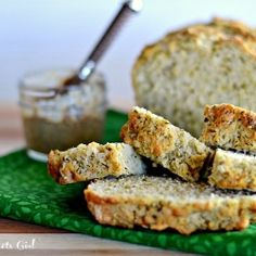 slices of bread sitting on top of a green napkin next to a jar of peanut butter