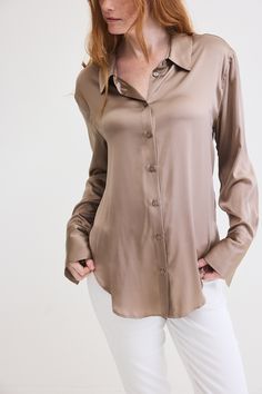 Turn heads in the Shift Your Gaze Silk Button Down, a romantic and luxurious addition to any look. The elegant silhouette provides a comfortable and relaxed fit, allowing you to move freely and gracefully Elegant Beige Blouse With Button Closure, Chic Viscose Shirt With Button Closure, Viscose Button-up Blouse, Viscose Button-up Blouse With Button Closure, Elegant Viscose Shirt With Button Closure, Chic Viscose Shirt, Elegant Viscose Shirt, Elegant Beige Blouse With Buttons, The Shift