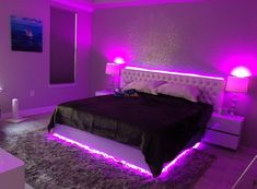 a bed with purple lights in a bedroom