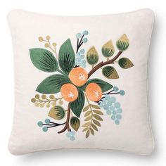 an embroidered pillow with flowers and leaves on it